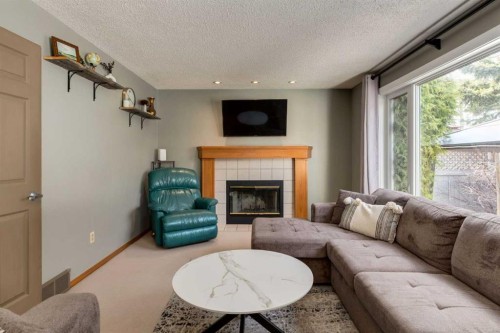 159 Macewan Drive Nw, Calgary, AB - Indoor Photo Showing Living Room With Fireplace