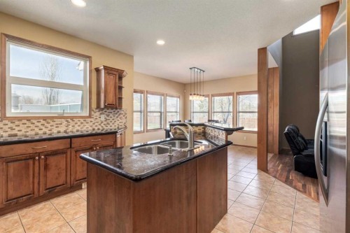 15 Barber Street Nw, Langdon, AB - Indoor Photo Showing Kitchen With Double Sink