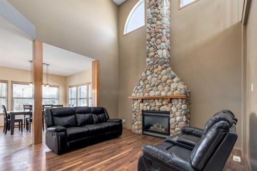 15 Barber Street Nw, Langdon, AB - Indoor Photo Showing Living Room With Fireplace