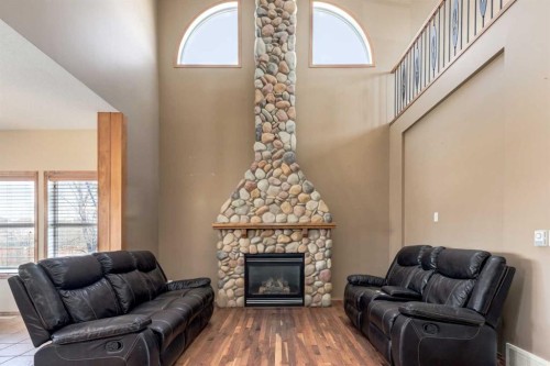 15 Barber Street Nw, Langdon, AB - Indoor Photo Showing Living Room With Fireplace