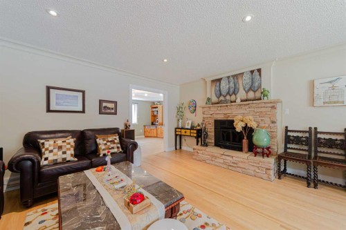 1239 Beverley Boulevard Sw, Calgary, AB - Indoor Photo Showing Living Room With Fireplace