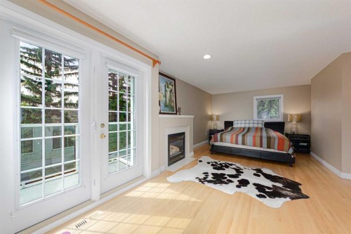 1239 Beverley Boulevard Sw, Calgary, AB - Indoor Photo Showing Bedroom With Fireplace