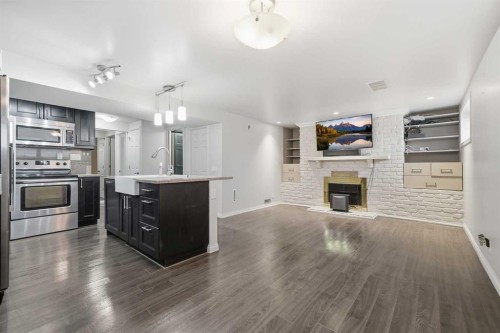 95 Summerwood Road, Airdrie, AB - Indoor Photo Showing Kitchen With Fireplace