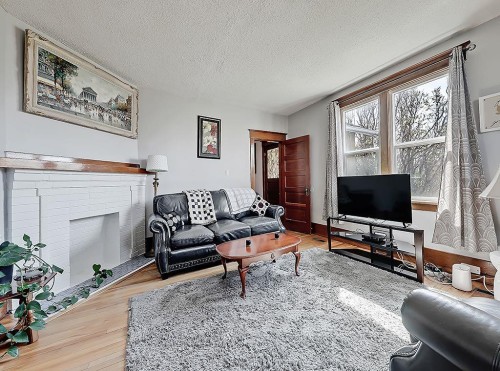 5136 54 Avenue, Stavely, AB - Indoor Photo Showing Living Room With Fireplace