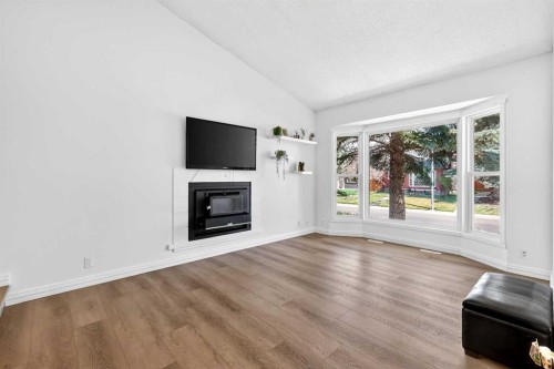 236 Mckerrell Way Se, Calgary, AB - Indoor Photo Showing Living Room With Fireplace