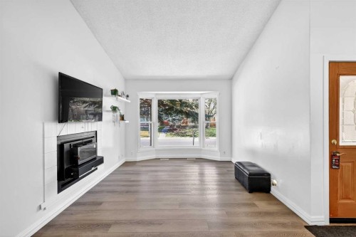 236 Mckerrell Way Se, Calgary, AB - Indoor Photo Showing Living Room With Fireplace