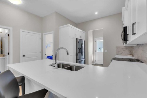 146 Highview Gate Se, Airdrie, AB - Indoor Photo Showing Kitchen With Double Sink