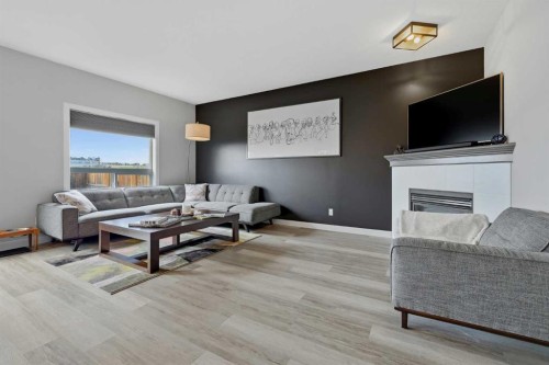 115 Everwoods Park Sw, Calgary, AB - Indoor Photo Showing Living Room With Fireplace