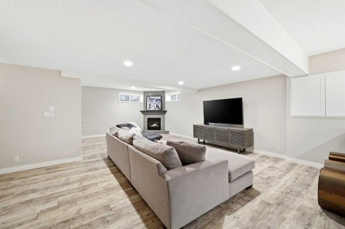 244 Cove Road, Chestermere, AB - Indoor Photo Showing Other Room With Fireplace