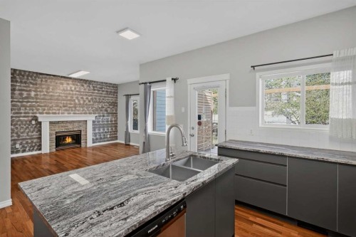 36 Chaparral Drive, Calgary, AB - Indoor Photo Showing Kitchen With Fireplace With Double Sink