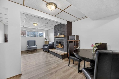 35 Queen Isabella Close Se, Calgary, AB - Indoor With Fireplace