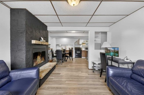 35 Queen Isabella Close Se, Calgary, AB - Indoor Photo Showing Living Room With Fireplace