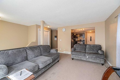 43 Abbercove Road Se, Calgary, AB - Indoor Photo Showing Living Room