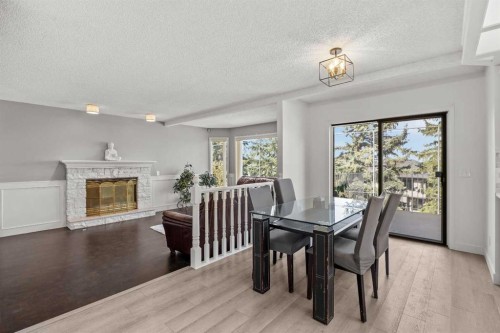 1360 Shawnee Road Sw, Calgary, AB - Indoor Photo Showing Dining Room With Fireplace