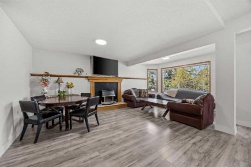 1360 Shawnee Road Sw, Calgary, AB - Indoor Photo Showing Living Room With Fireplace