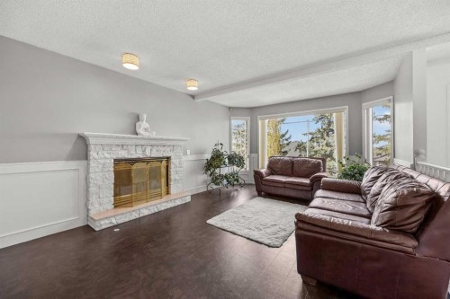 1360 Shawnee Road Sw, Calgary, AB - Indoor Photo Showing Living Room With Fireplace