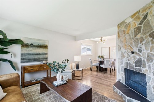 48 Haddock Road Sw, Calgary, AB - Indoor Photo Showing Living Room With Fireplace