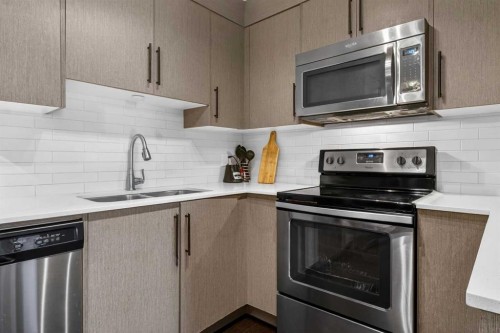 4403-302 Skyview Ranch Drive Ne, Calgary, AB - Indoor Photo Showing Kitchen With Stainless Steel Kitchen With Double Sink With Upgraded Kitchen