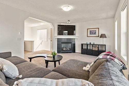 30 Drake Landing Common, Okotoks, AB - Indoor Photo Showing Living Room With Fireplace