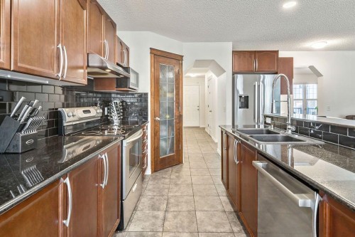 30 Drake Landing Common, Okotoks, AB - Indoor Photo Showing Kitchen With Double Sink With Upgraded Kitchen