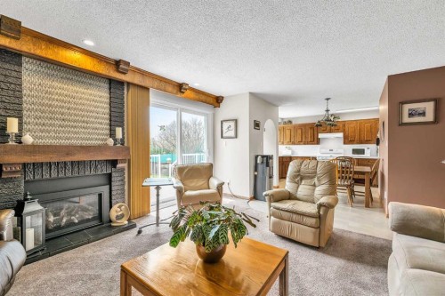288 Deer Run Crescent Se, Calgary, AB - Indoor Photo Showing Living Room With Fireplace