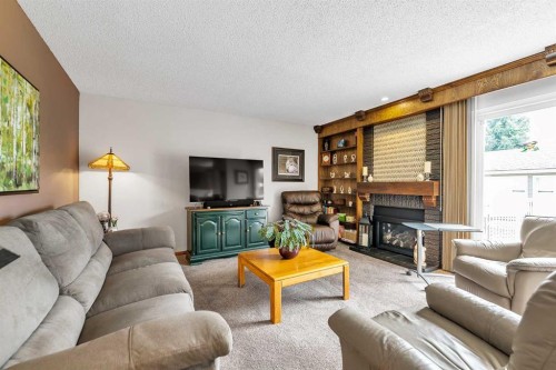 288 Deer Run Crescent Se, Calgary, AB - Indoor Photo Showing Living Room With Fireplace