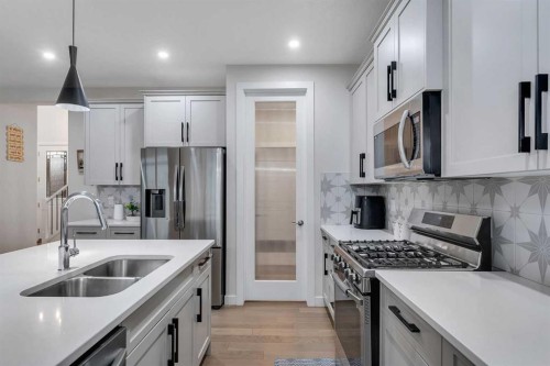 110 Waterford Road, Chestermere, AB - Indoor Photo Showing Kitchen With Stainless Steel Kitchen With Double Sink With Upgraded Kitchen