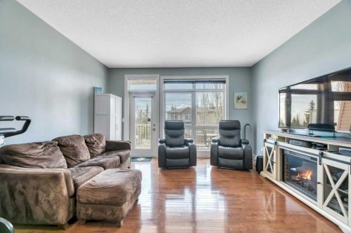 8-172 Rockyledge View Nw, Calgary, AB - Indoor Photo Showing Living Room With Fireplace