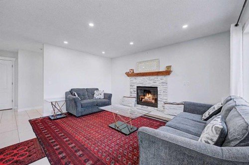 644 Luxstone Landing Sw, Airdrie, AB - Indoor Photo Showing Living Room With Fireplace