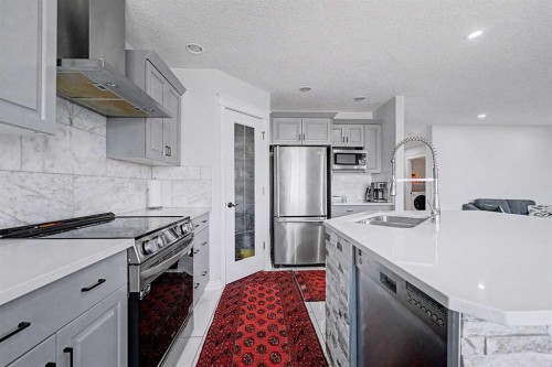 644 Luxstone Landing Sw, Airdrie, AB - Indoor Photo Showing Kitchen With Stainless Steel Kitchen With Double Sink With Upgraded Kitchen