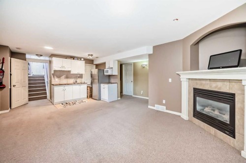 44 Canoe Square Sw, Airdrie, AB - Indoor Photo Showing Living Room With Fireplace