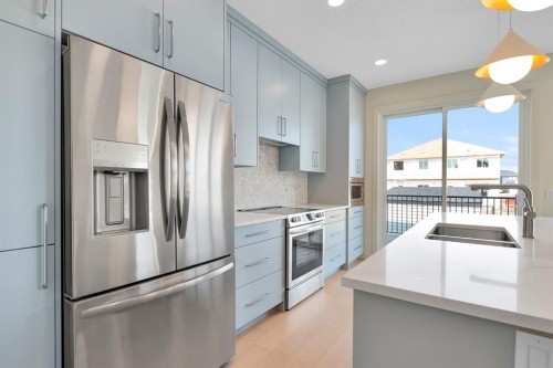 96 Fireside Common, Cochrane, AB - Indoor Photo Showing Kitchen With Stainless Steel Kitchen With Double Sink With Upgraded Kitchen