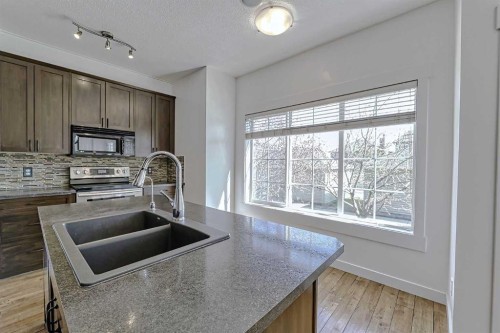 179 Rainbow Falls Drive, Chestermere, AB - Indoor Photo Showing Kitchen With Double Sink With Upgraded Kitchen