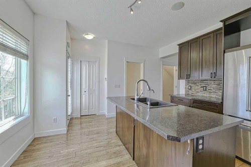 179 Rainbow Falls Drive, Chestermere, AB - Indoor Photo Showing Kitchen With Double Sink