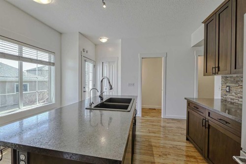 179 Rainbow Falls Drive, Chestermere, AB - Indoor Photo Showing Kitchen With Double Sink