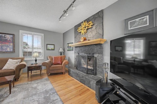 7 Straddock Crescent Sw, Calgary, AB - Indoor Photo Showing Living Room With Fireplace
