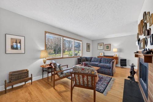 3811 24 Street Nw, Calgary, AB - Indoor Photo Showing Living Room With Fireplace