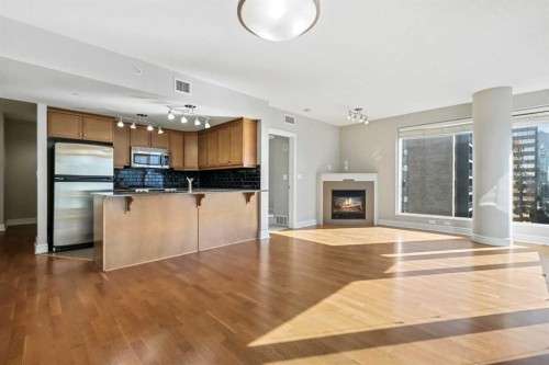 1607-910 5 Avenue Sw, Calgary, AB - Indoor Photo Showing Kitchen With Fireplace