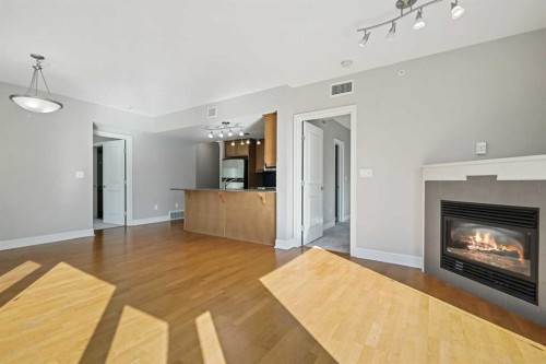 1607-910 5 Avenue Sw, Calgary, AB - Indoor Photo Showing Living Room With Fireplace