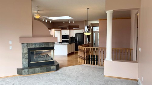 117 Woodpark Close Sw, Calgary, AB - Indoor Photo Showing Other Room With Fireplace
