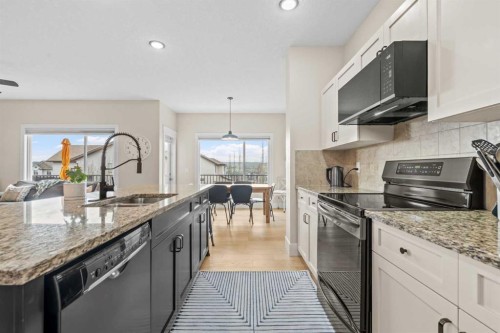 10 Heritage View, Cochrane, AB - Indoor Photo Showing Kitchen With Double Sink With Upgraded Kitchen
