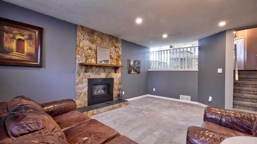 48 Riverbrook Road Se, Calgary, AB - Indoor Photo Showing Living Room With Fireplace