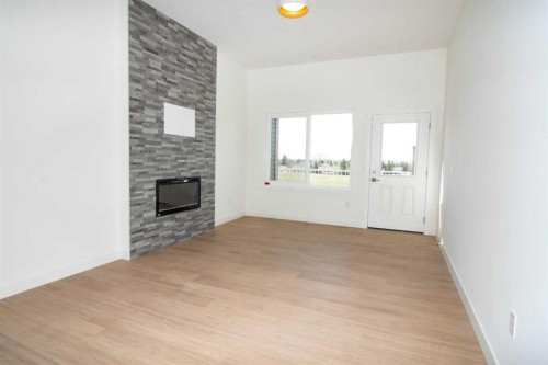 31 Wolf Crescent, Okotoks, AB - Indoor Photo Showing Other Room With Fireplace