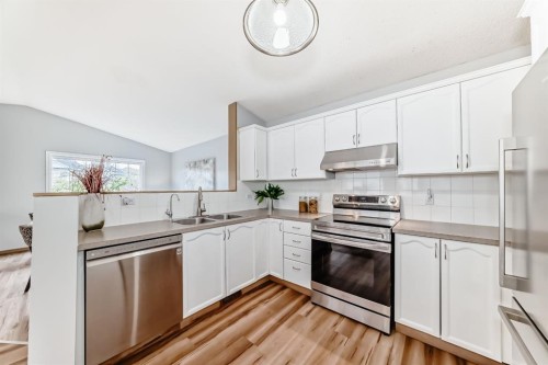 118 Bridleridge Way Sw, Calgary, AB - Indoor Photo Showing Kitchen With Double Sink