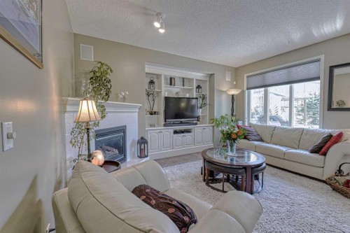 111 West Springs Way Sw, Calgary, AB - Indoor Photo Showing Living Room With Fireplace