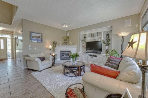 111 West Springs Way Sw, Calgary, AB - Indoor Photo Showing Living Room With Fireplace
