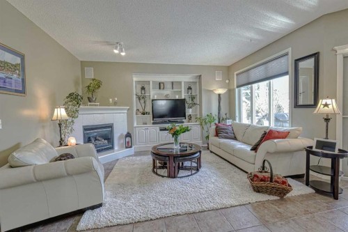 111 West Springs Way Sw, Calgary, AB - Indoor Photo Showing Living Room With Fireplace