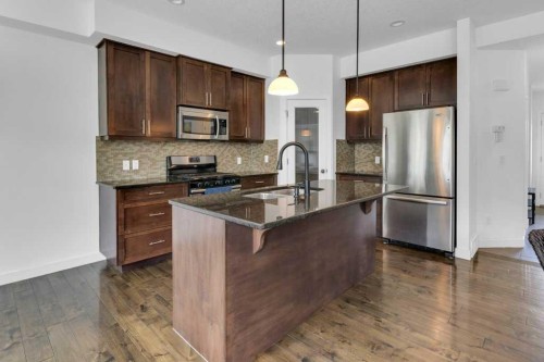 305-413 River Avenue, Cochrane, AB - Indoor Photo Showing Kitchen With Upgraded Kitchen