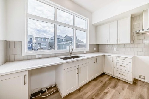 36 Mercado Road Se, Calgary, AB - Indoor Photo Showing Kitchen With Double Sink