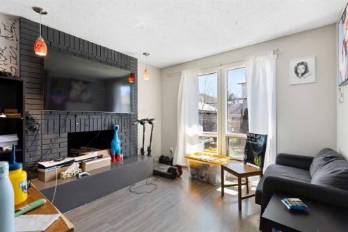 21 Mckernan Road Se, Calgary, AB - Indoor Photo Showing Living Room With Fireplace
